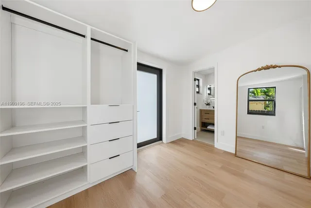 a bedroom with a large bed and a large window