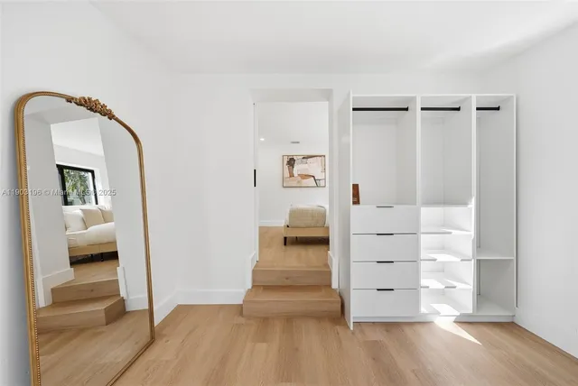 a bedroom with a bed and a painting on the wall