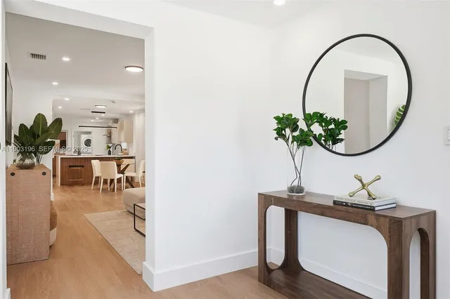 a kitchen with stainless steel appliances a sink and a refrigerator