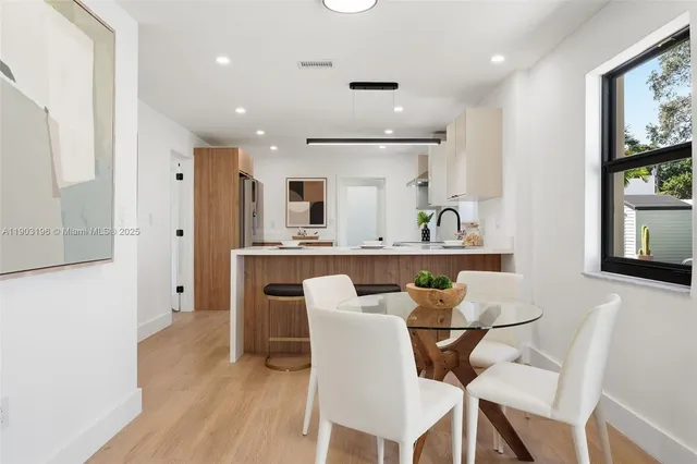 a view of washer and dryer with bathroom in the background