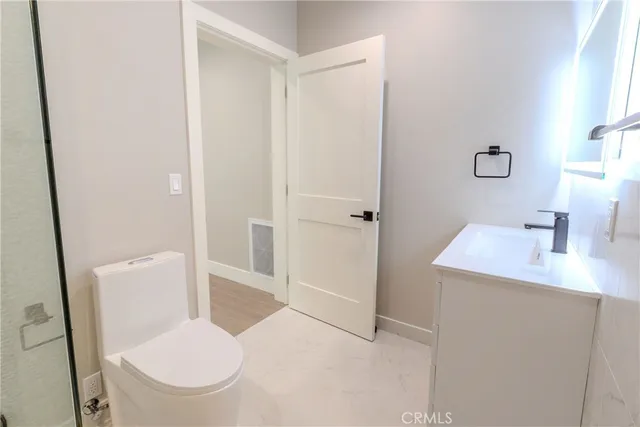 a kitchen with stainless steel appliances kitchen island granite countertop a refrigerator a sink and a stove