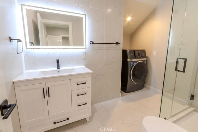 a view of an empty room with wooden floor and entryway