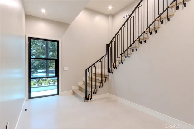 a view of an empty room with wooden floor and a floor to ceiling window