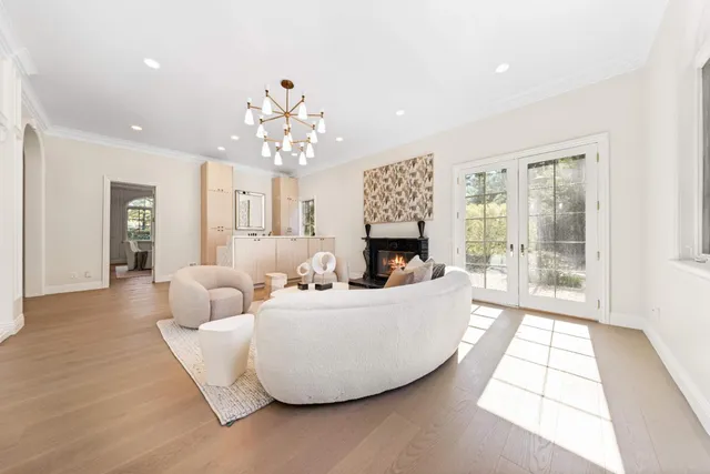 a view of a dining room with furniture wooden floor and a chandelier