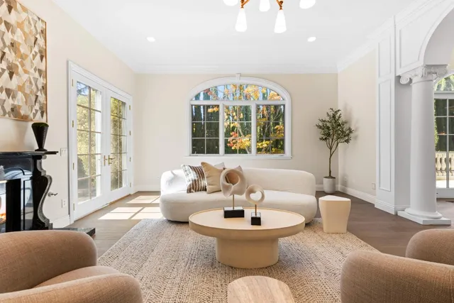 a view of a dining room with furniture a chandelier and a rug