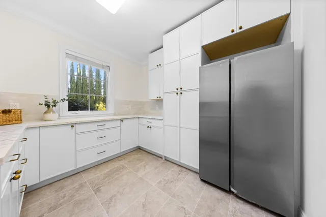 a spacious bathroom with a granite countertop sink a mirror and a shower
