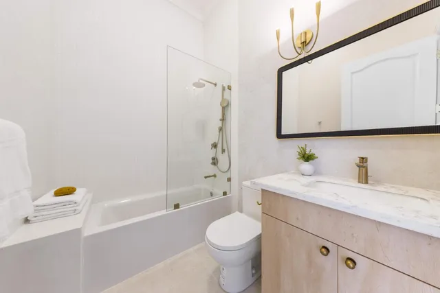 a living room with furniture a window and a flat screen tv
