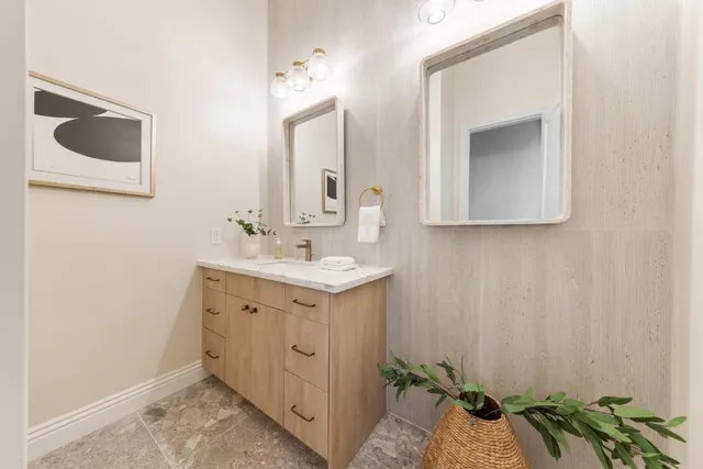 a living room with furniture and view of kitchen