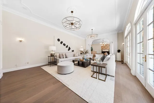 a view of a dining room with furniture a chandelier and wooden floor