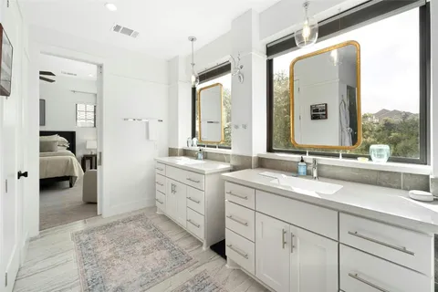 a spacious bathroom with a double vanity sink and mirror