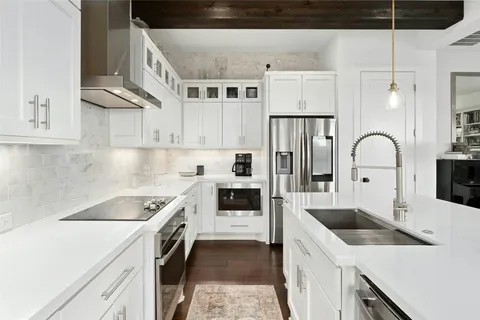 a kitchen with stainless steel appliances granite countertop a sink stove and refrigerator