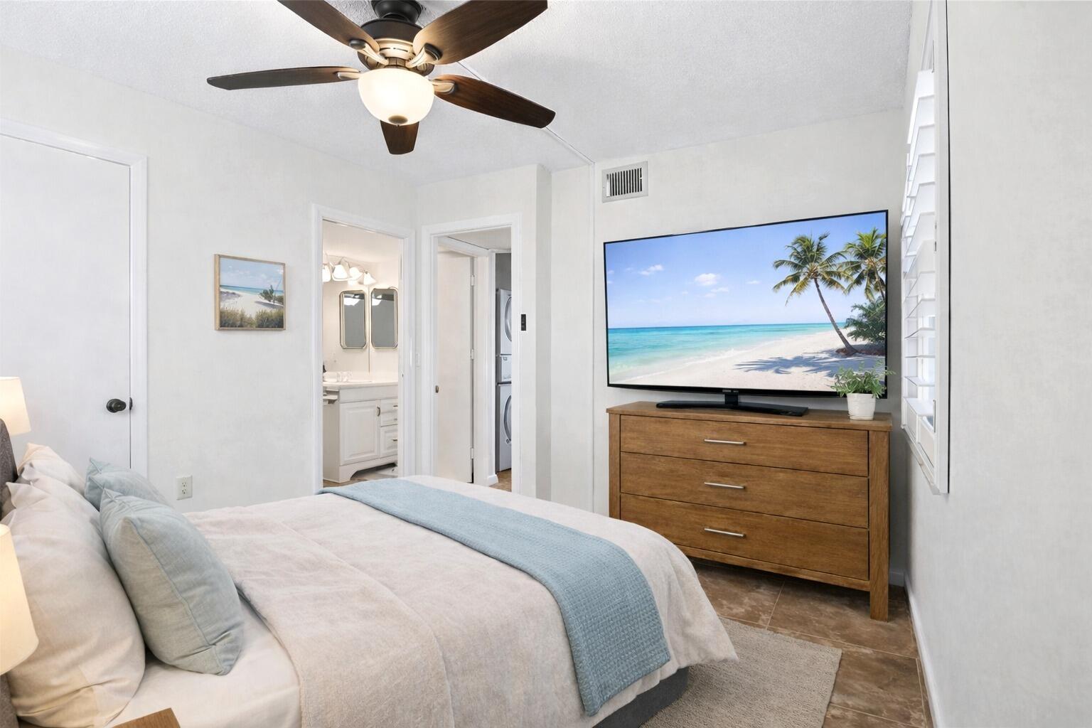 717 Highway 1, Unit 305 Jupiter, FL 33477 - Photo 13 of 51 a bedroom with a bed and a chandelier