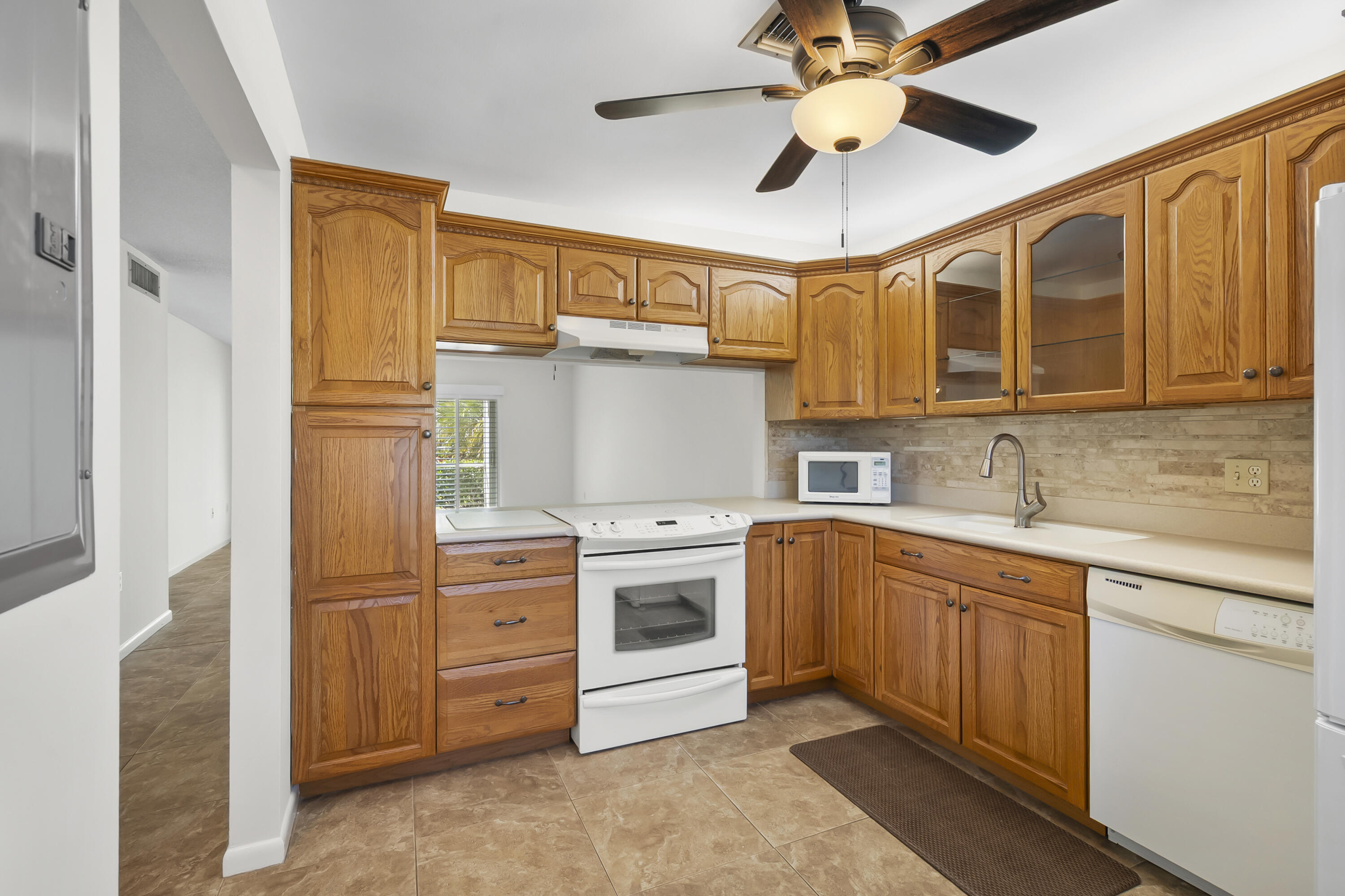 717 Highway 1, Unit 305 Jupiter, FL 33477 - Photo 15 of 51 a kitchen with stainless steel appliances granite countertop a sink and cabinets