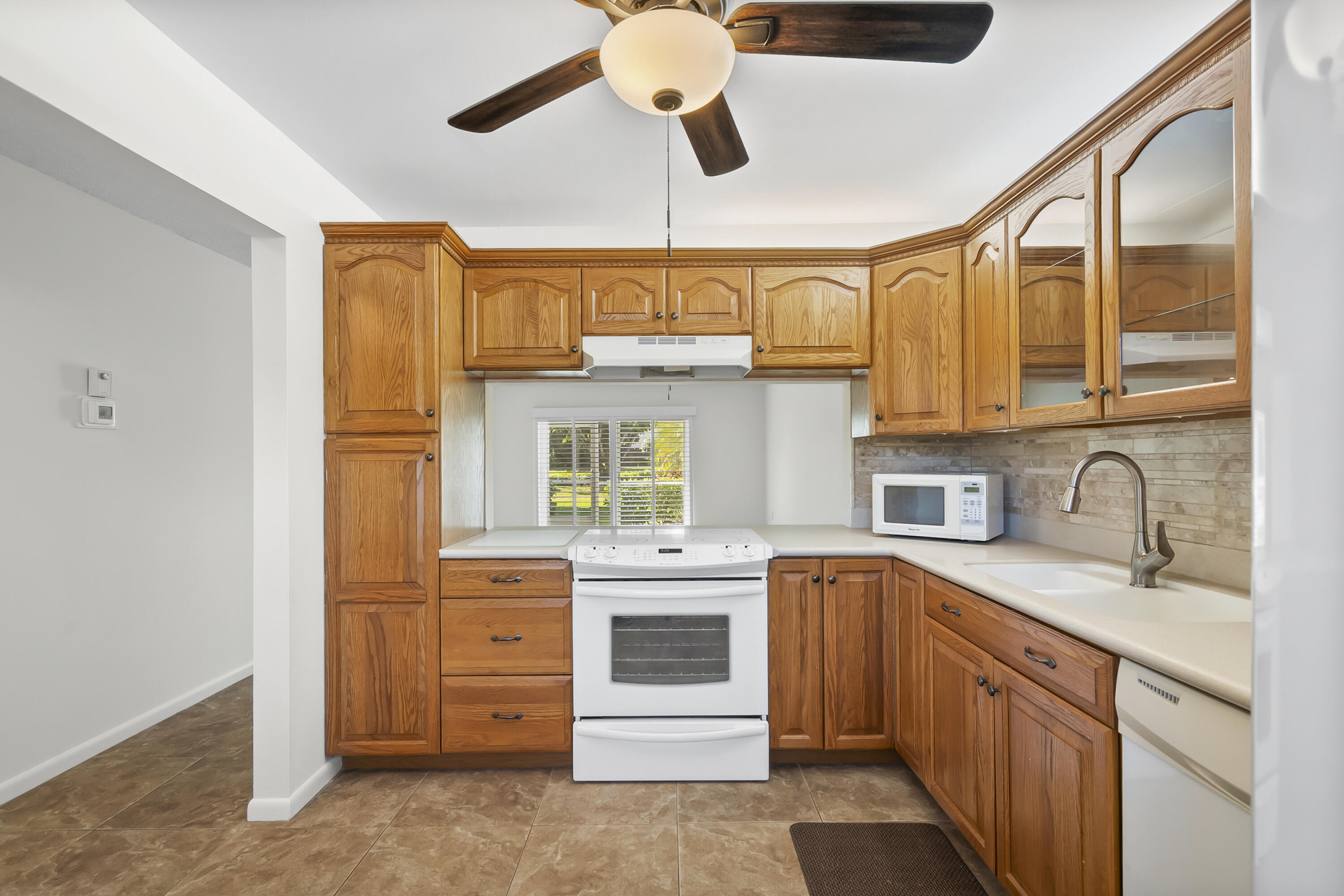 717 Highway 1, Unit 305 Jupiter, FL 33477 - Photo 16 of 51 a kitchen with stainless steel appliances granite countertop a sink and cabinets