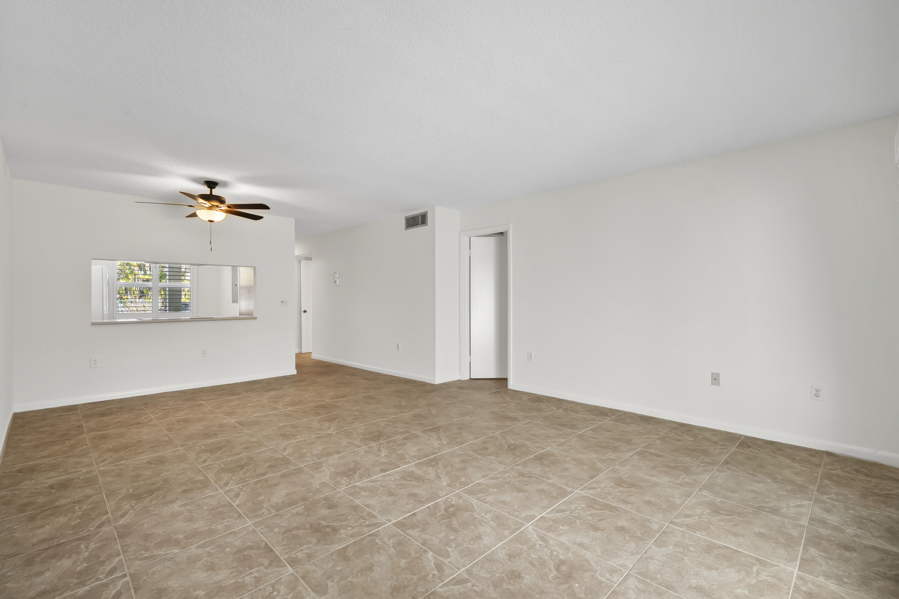 717 Highway 1, Unit 305 Jupiter, FL 33477 - Photo 17 of 51 a view of a big room with wooden floor and windows