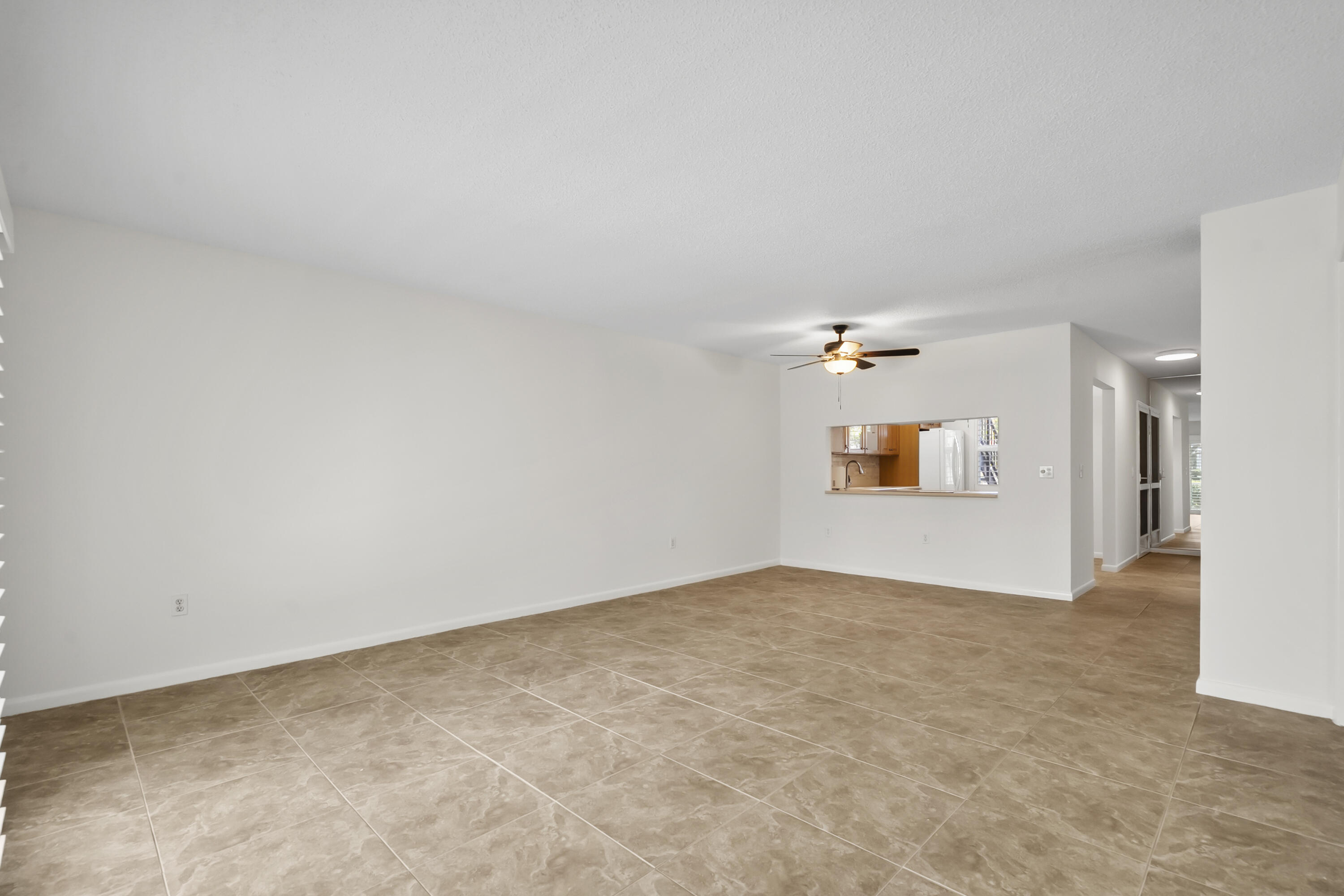 717 Highway 1, Unit 305 Jupiter, FL 33477 - Photo 18 of 51 a view of a big room with wooden floor and windows