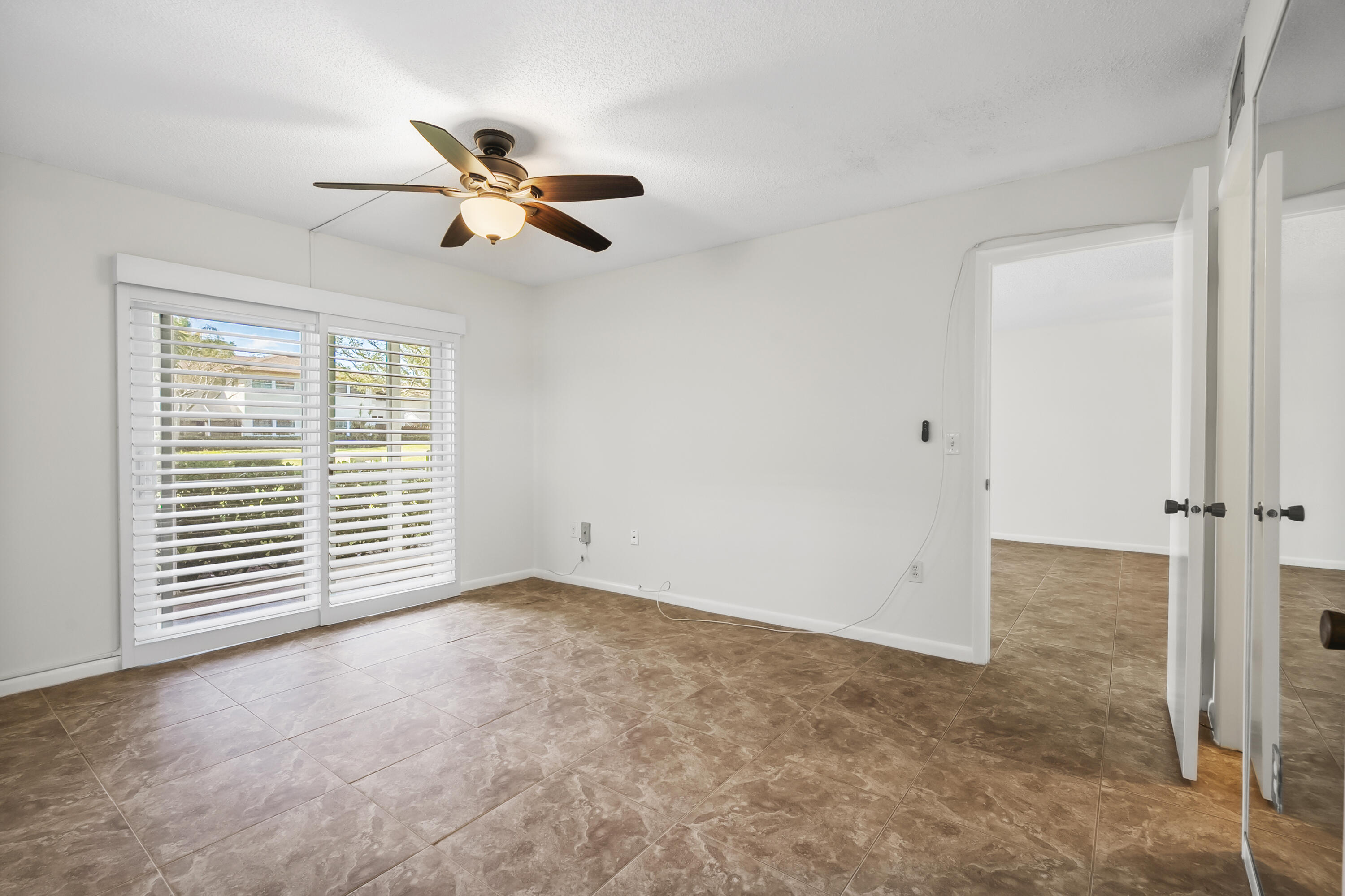 717 Highway 1, Unit 305 Jupiter, FL 33477 - Photo 22 of 51 an empty room with windows and fan