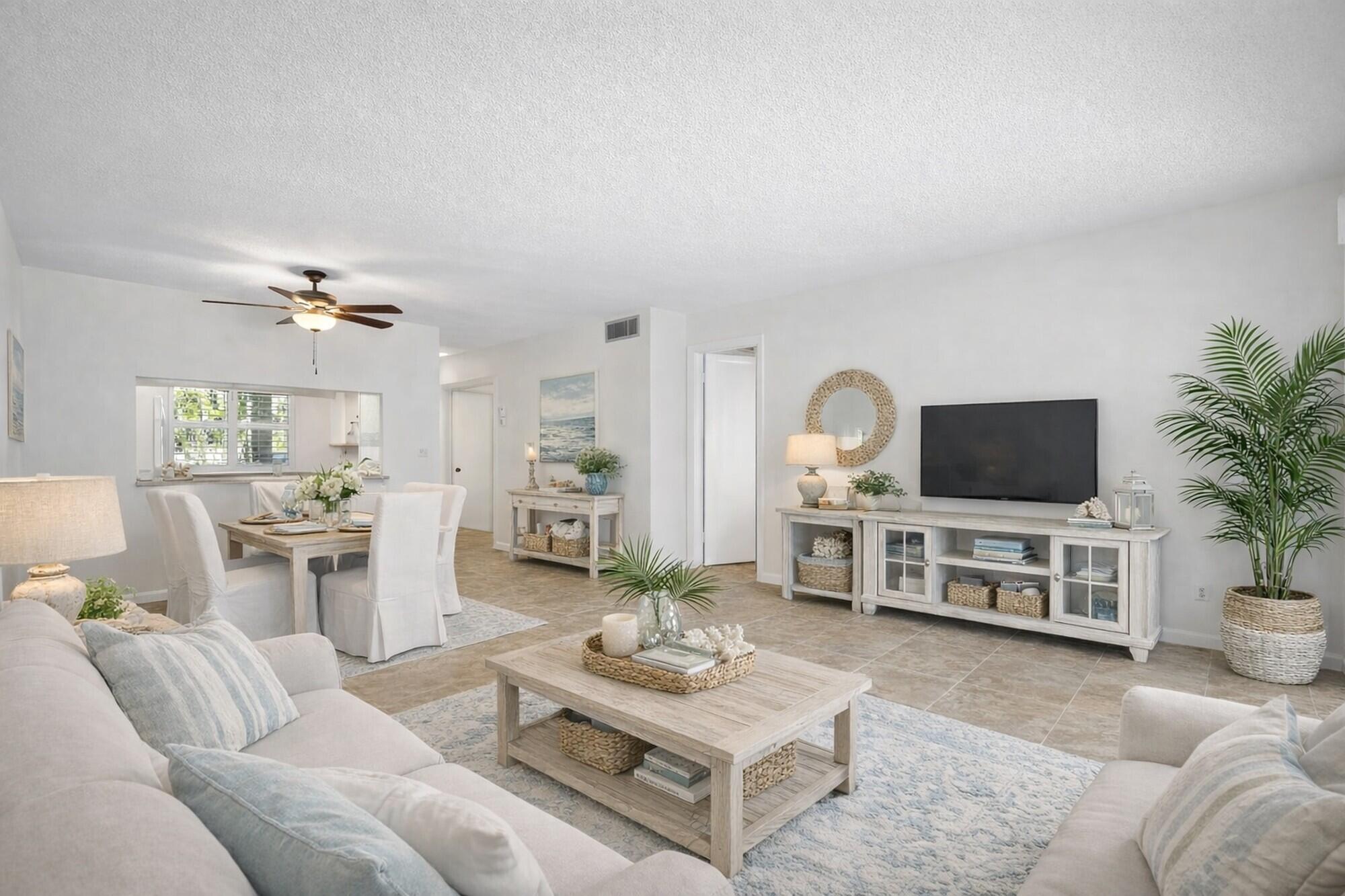 717 Highway 1, Unit 305 Jupiter, FL 33477 - Photo 4 of 51 a living room with furniture and a flat screen tv