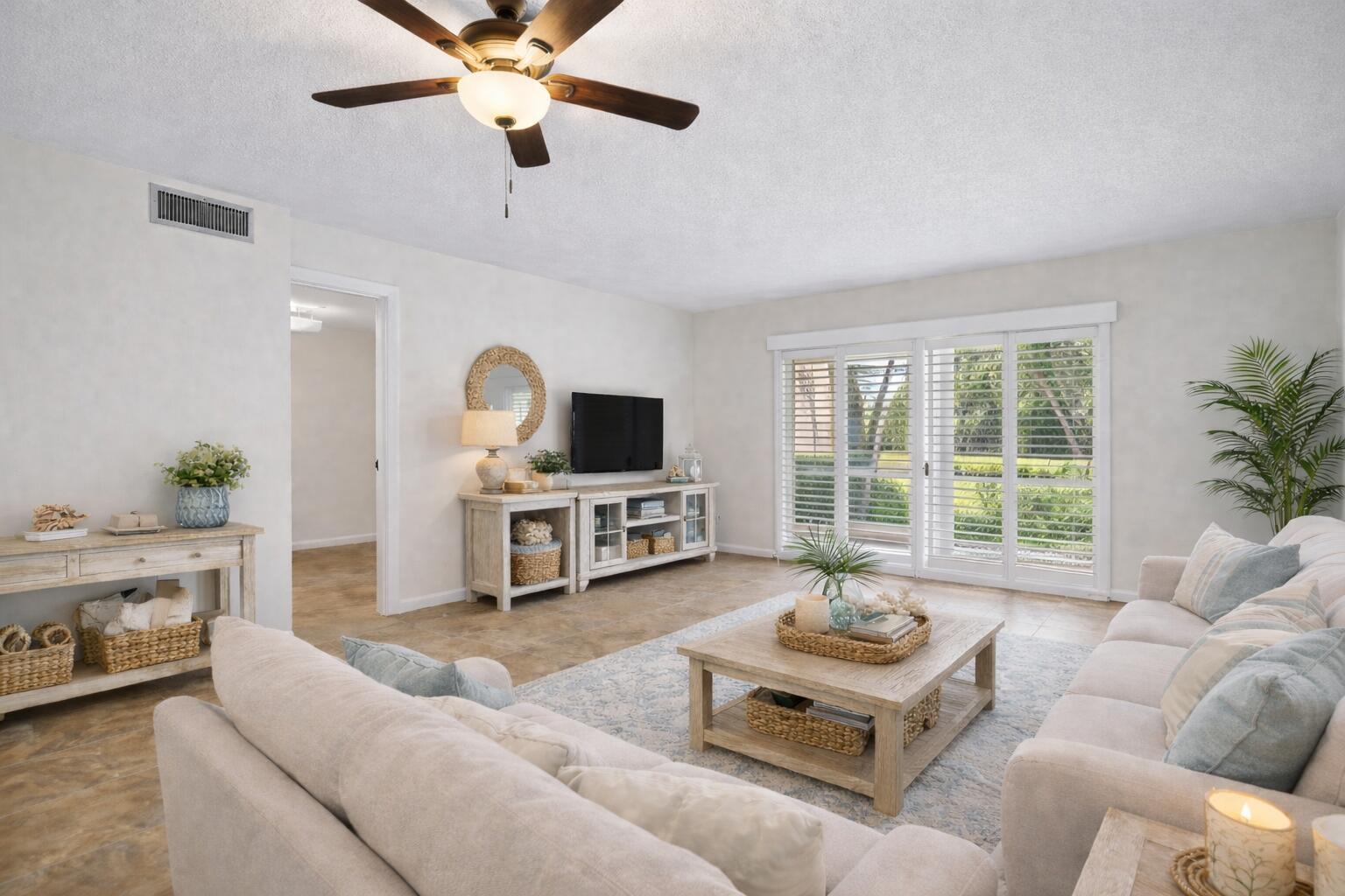 717 Highway 1, Unit 305 Jupiter, FL 33477 - Photo 6 of 51 a living room with furniture a flat screen tv and a large window