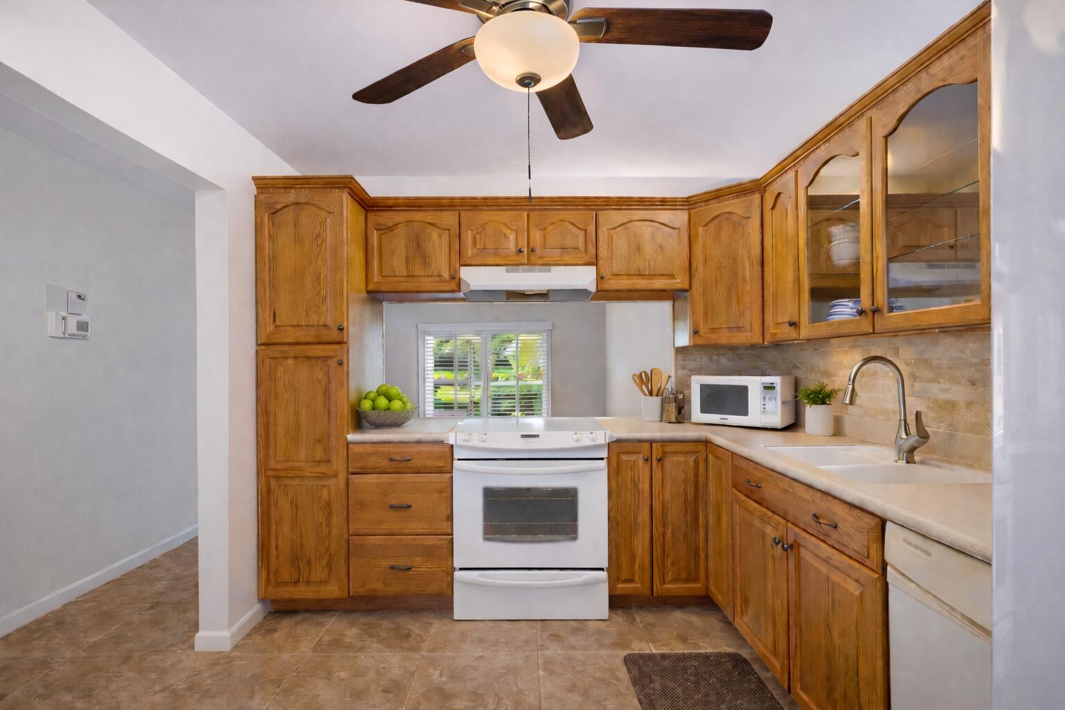 717 Highway 1, Unit 305 Jupiter, FL 33477 - Photo 8 of 51 a kitchen with kitchen island a stove a sink and cabinets