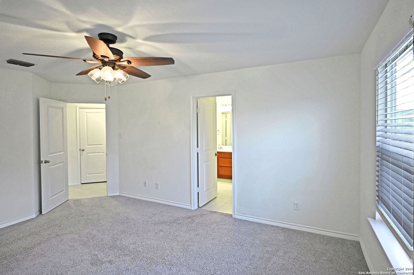 512 Dakota Creek New Braunfels, TX 78130 - Photo 12 of 38 a view of an empty room and window with a ceiling fan