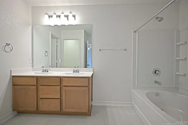 a bathroom with a sink a shower and a mirror