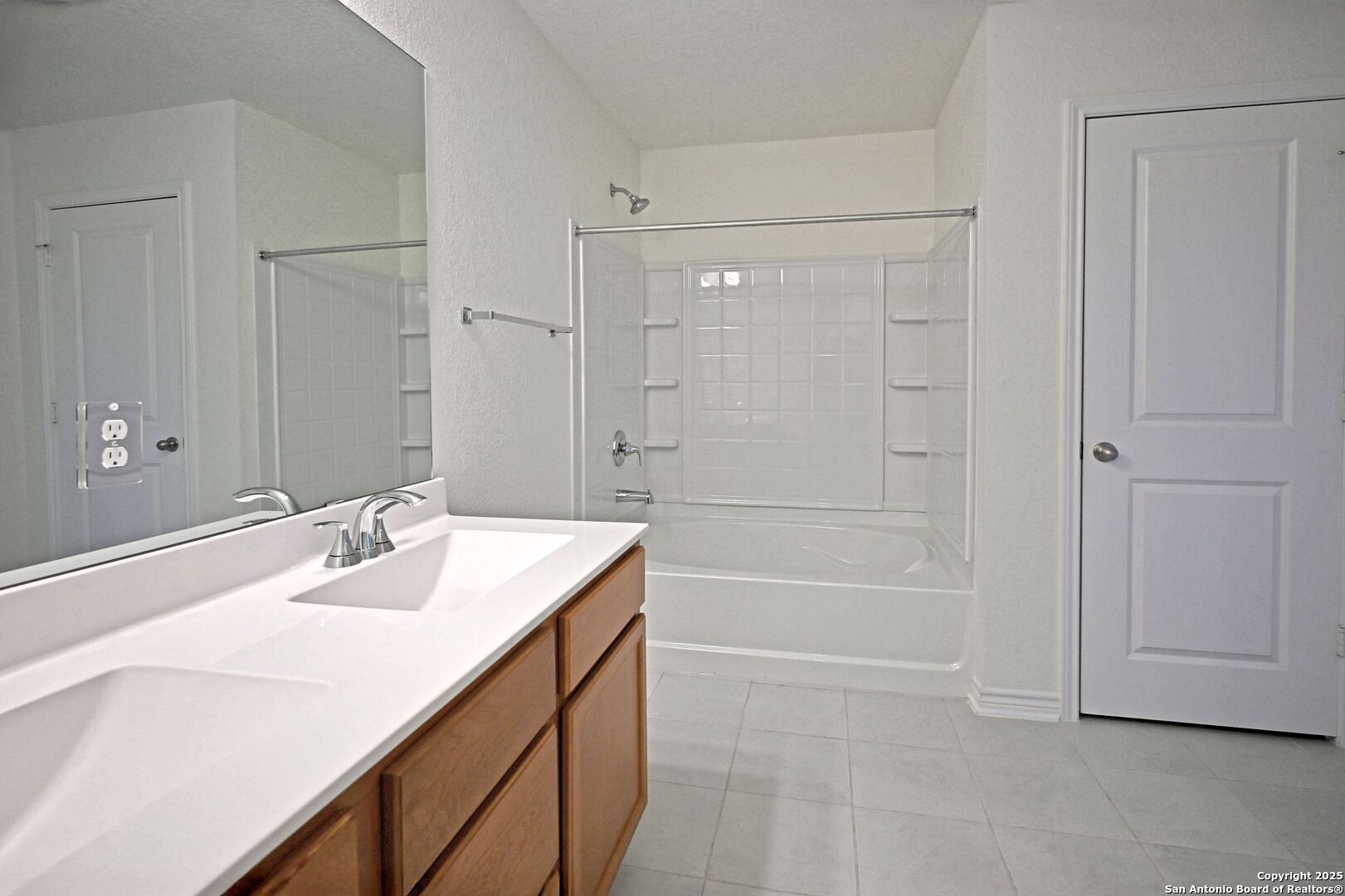 512 Dakota Creek New Braunfels, TX 78130 - Photo 14 of 38 a bathroom with a sink a shower and a mirror