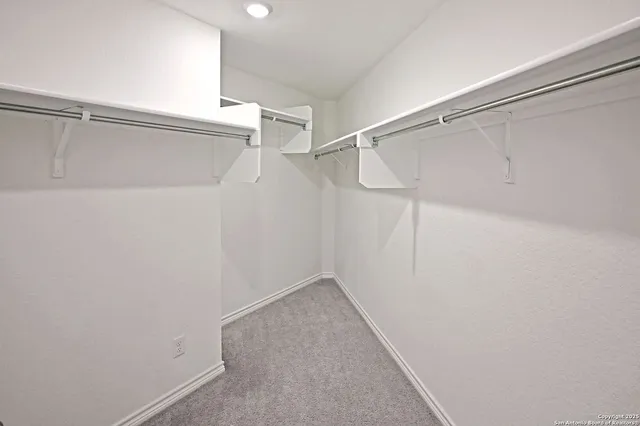 a large kitchen with kitchen island a sink a stove and a refrigerator