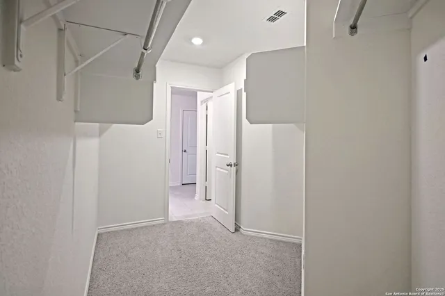 a large kitchen with kitchen island a sink a counter top stainless steel appliances and cabinets