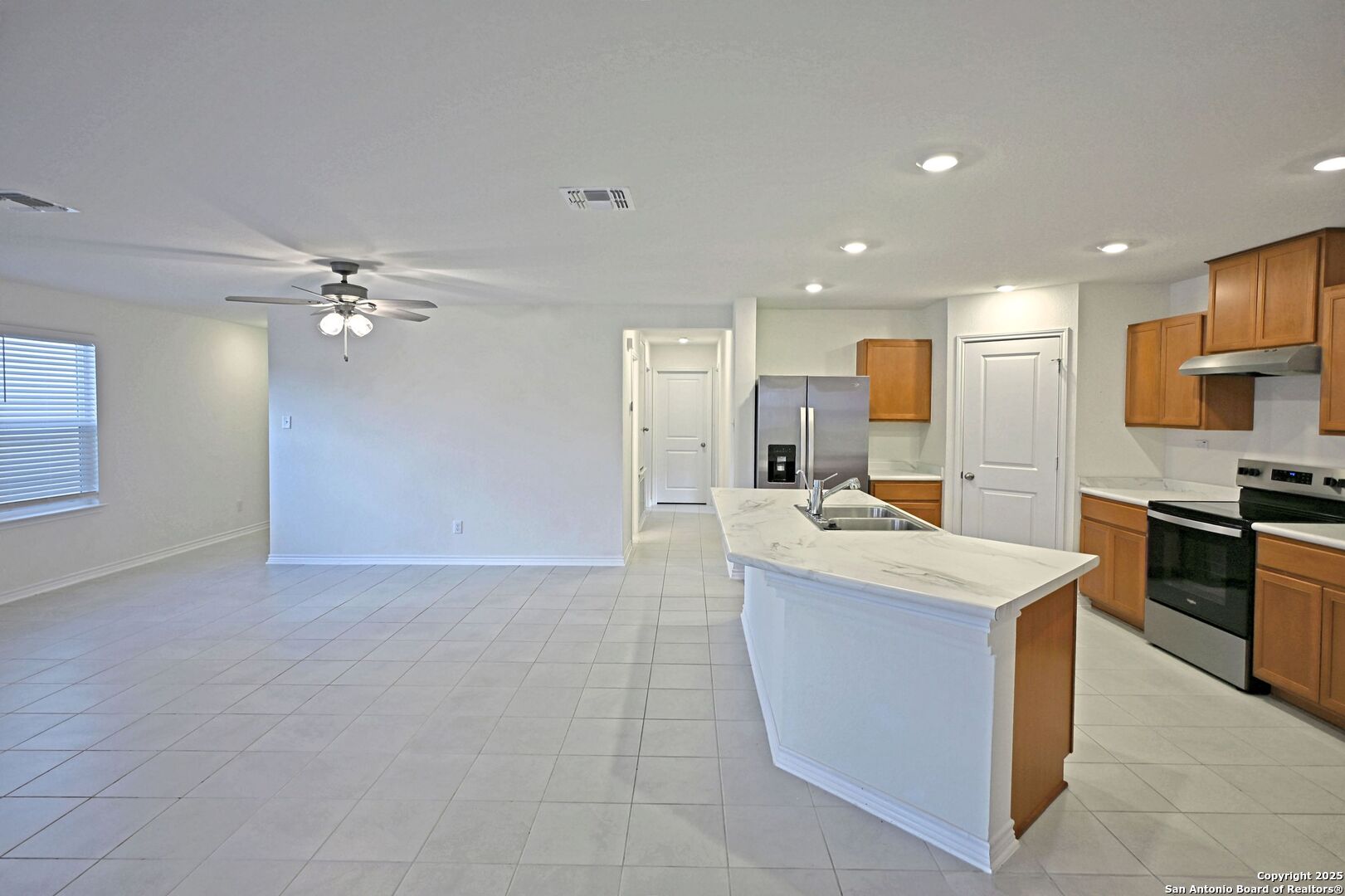512 Dakota Creek New Braunfels, TX 78130 - Photo 17 of 38 a large kitchen with kitchen island a sink a stove and a refrigerator