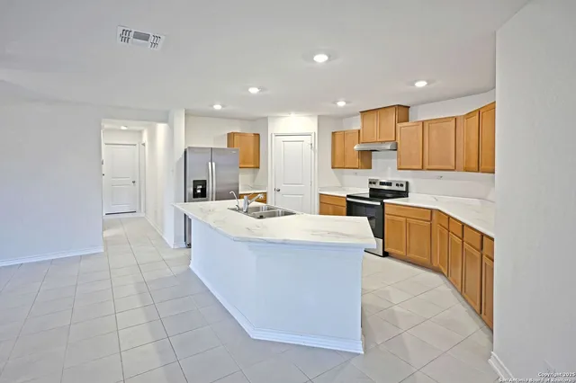 a bathroom with a granite countertop sink a toilet and shower