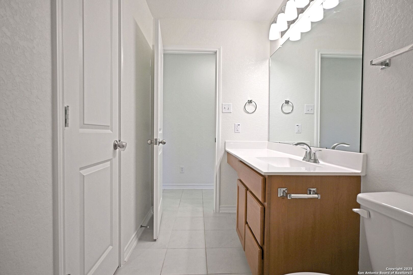 512 Dakota Creek New Braunfels, TX 78130 - Photo 20 of 38 a bathroom with a granite countertop sink a toilet and shower