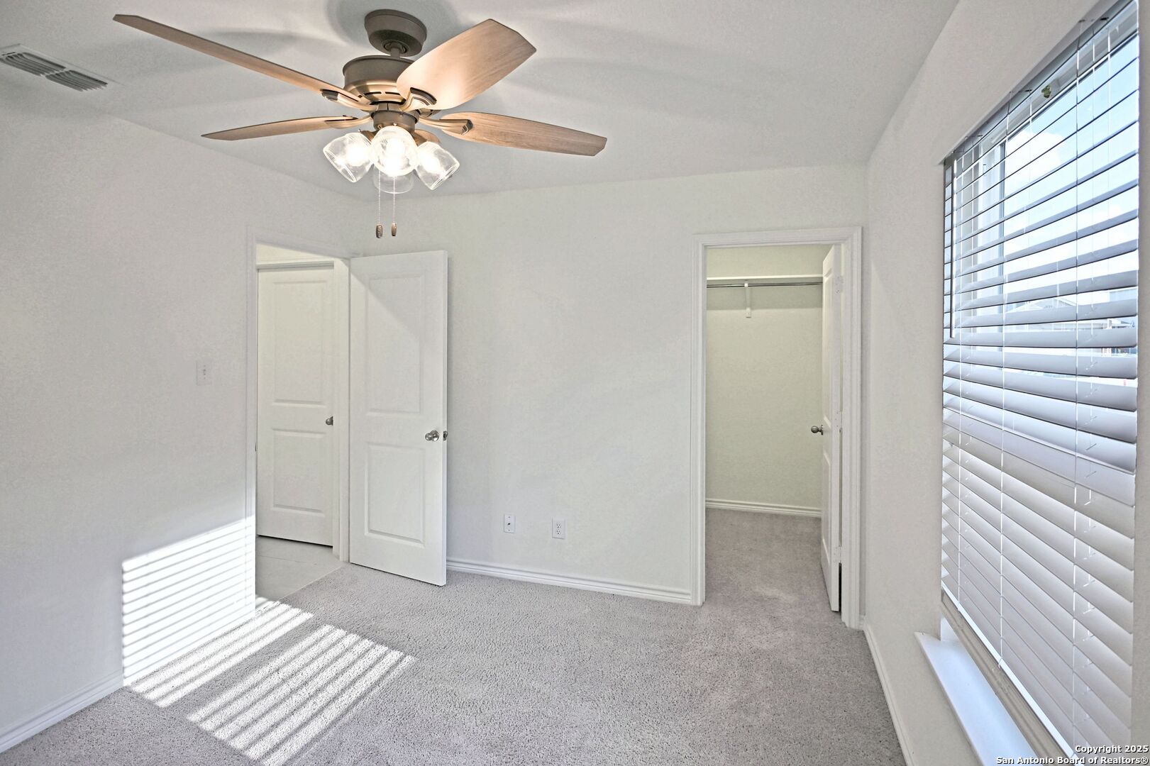 512 Dakota Creek New Braunfels, TX 78130 - Photo 23 of 38 a view of a livingroom with a chandelier fan and a window