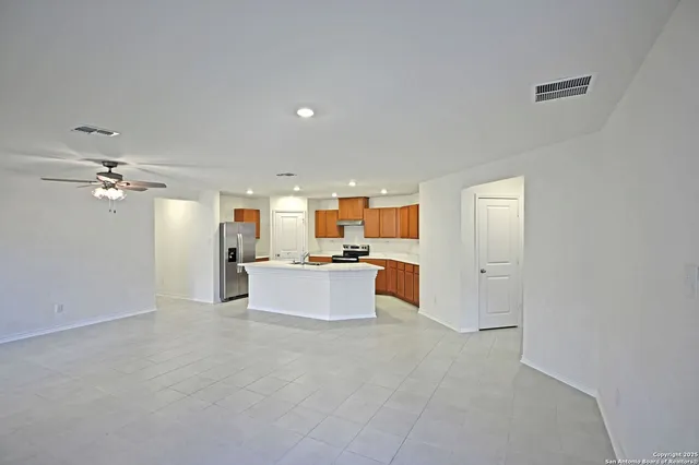 a kitchen with white cabinets and appliances