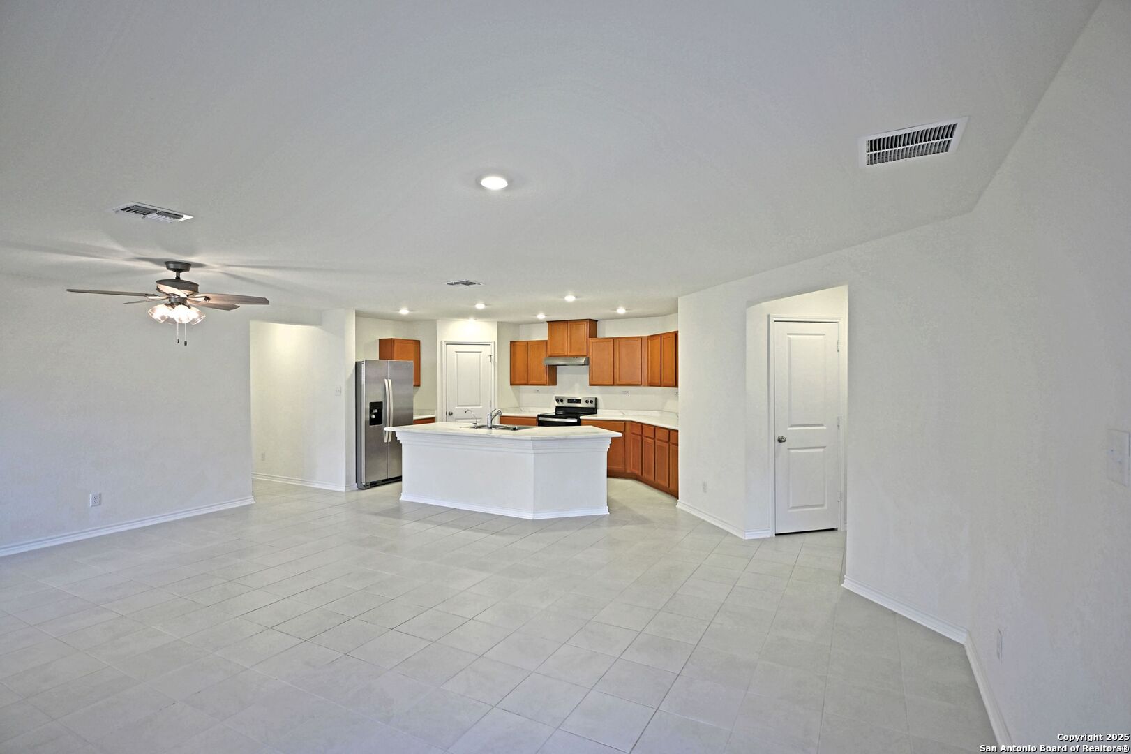 512 Dakota Creek New Braunfels, TX 78130 - Photo 6 of 38 a living room with kitchen island furniture and a kitchen view