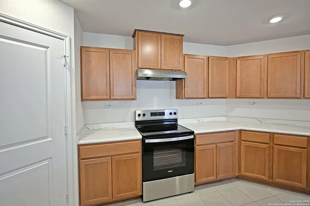 a kitchen with a sink stove and cabinets