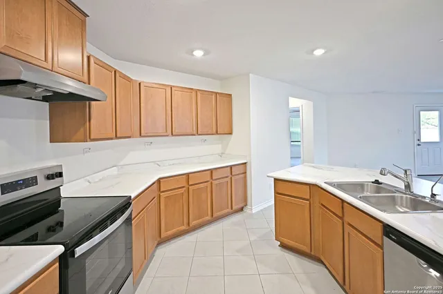 a kitchen with cabinets and chandelier