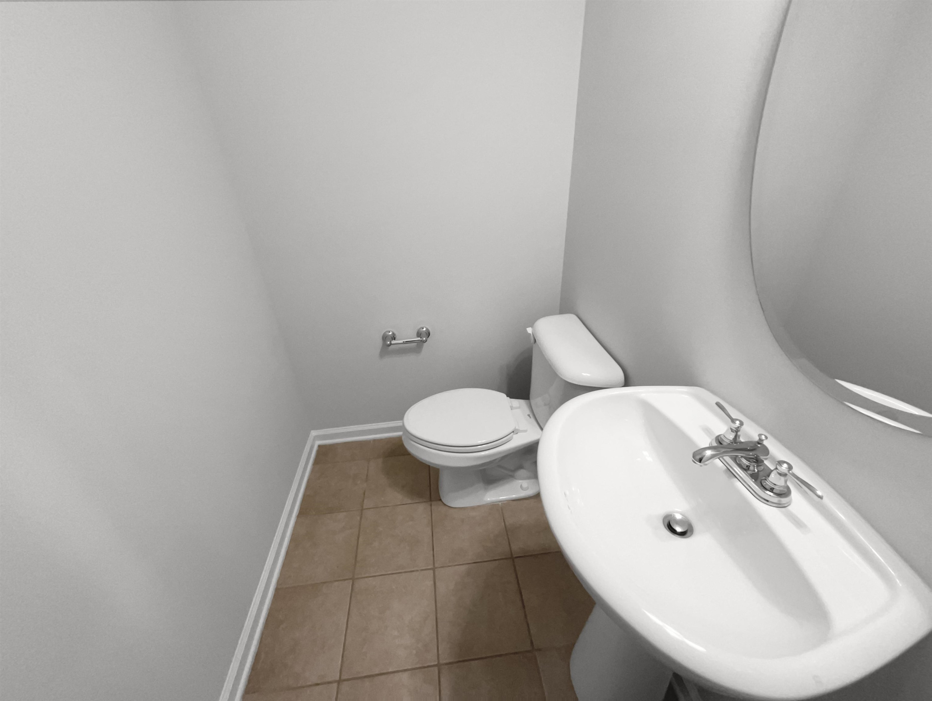 3154 Groveshire Drive Raleigh, NC 27616 - Photo 12 of 20 a bathroom with a sink a toilet and a mirror