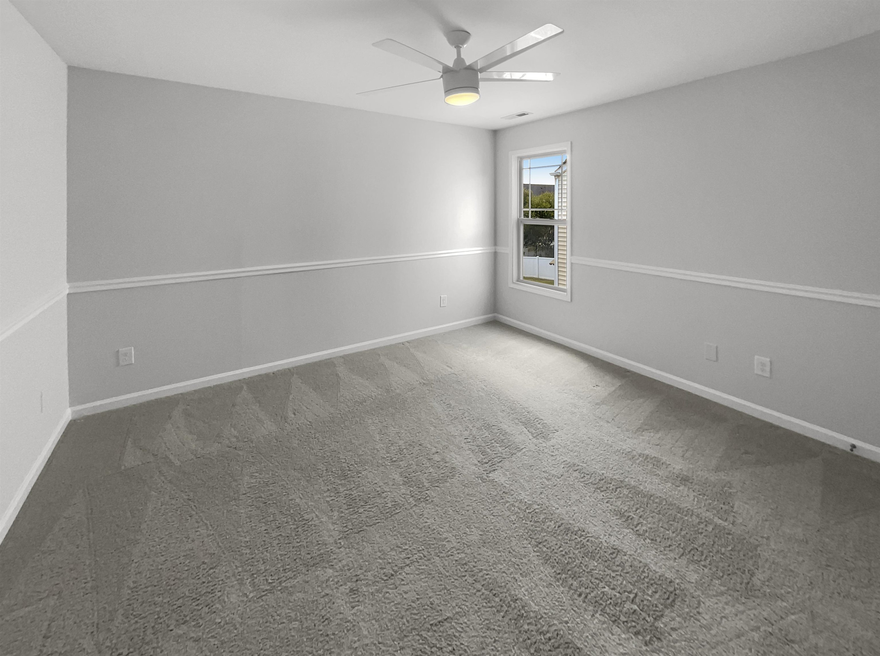 3154 Groveshire Drive Raleigh, NC 27616 - Photo 15 of 20 an empty room with windows and ceiling fan