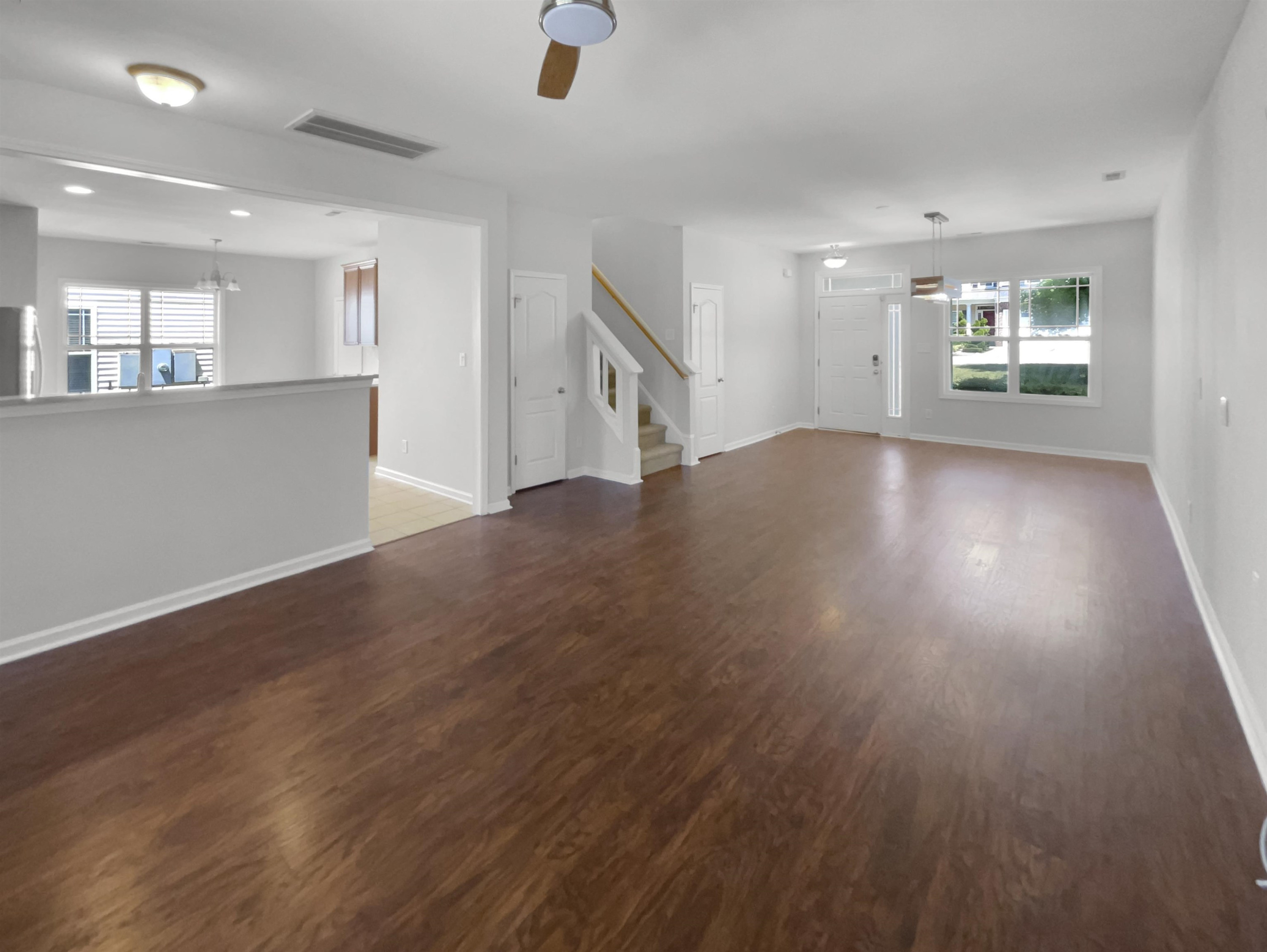 3154 Groveshire Drive Raleigh, NC 27616 - Photo 3 of 20 an empty room with wooden floor and windows