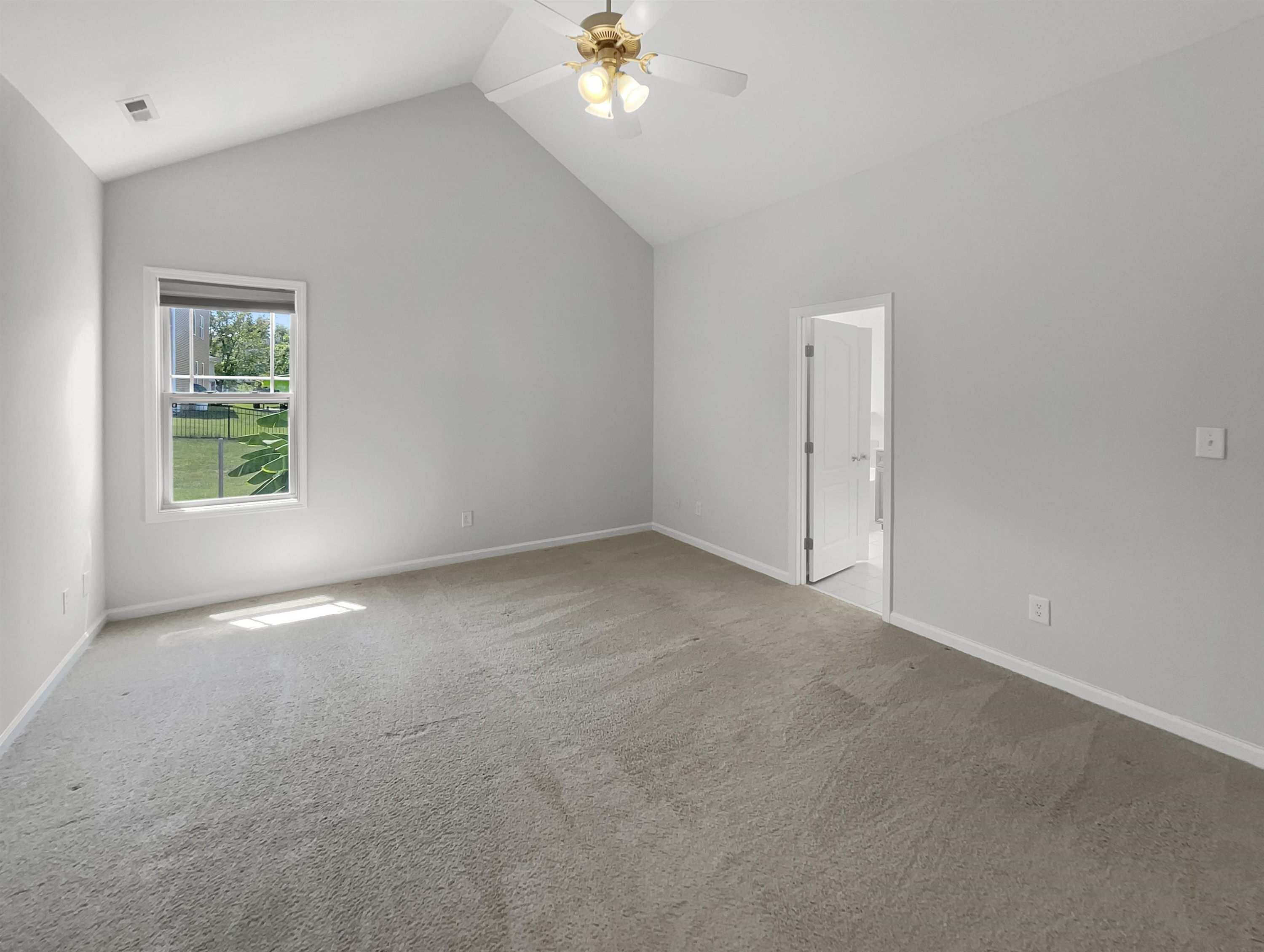 3154 Groveshire Drive Raleigh, NC 27616 - Photo 5 of 20 an empty room with a chandelier fan and windows