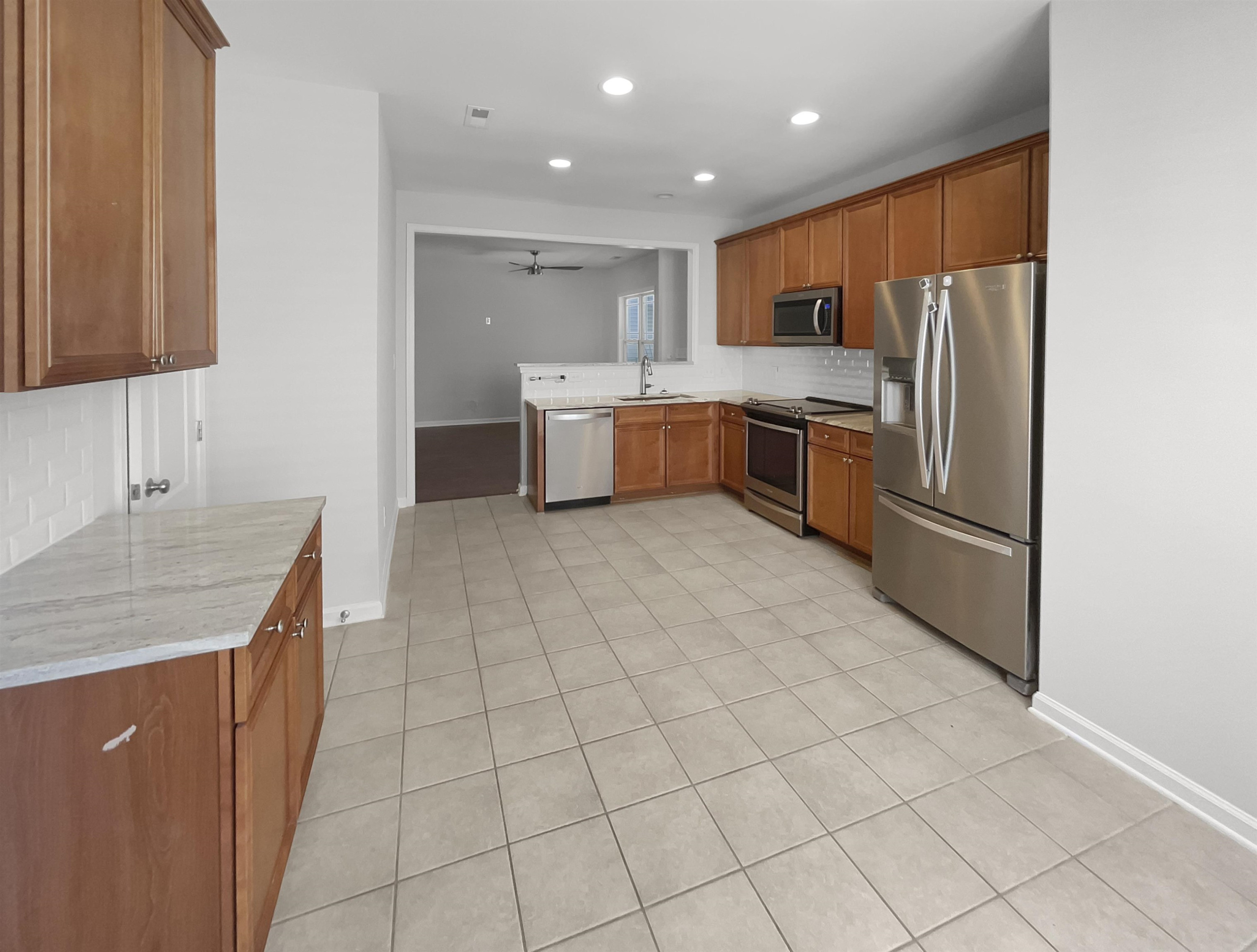 3154 Groveshire Drive Raleigh, NC 27616 - Photo 6 of 20 a kitchen with stainless steel appliances granite countertop a sink refrigerator and cabinets