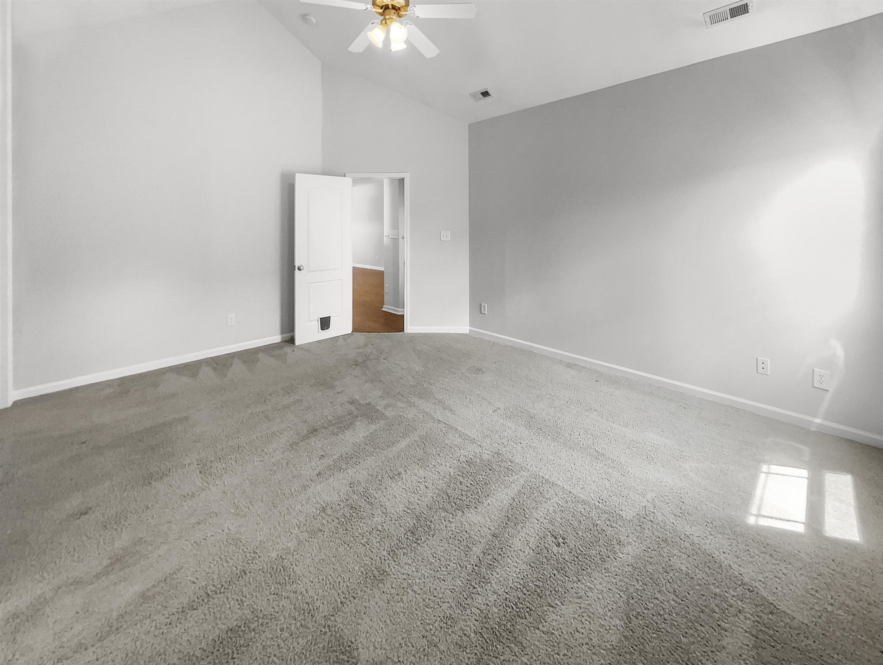 3154 Groveshire Drive Raleigh, NC 27616 - Photo 9 of 20 a view of an empty room with a chandelier fan