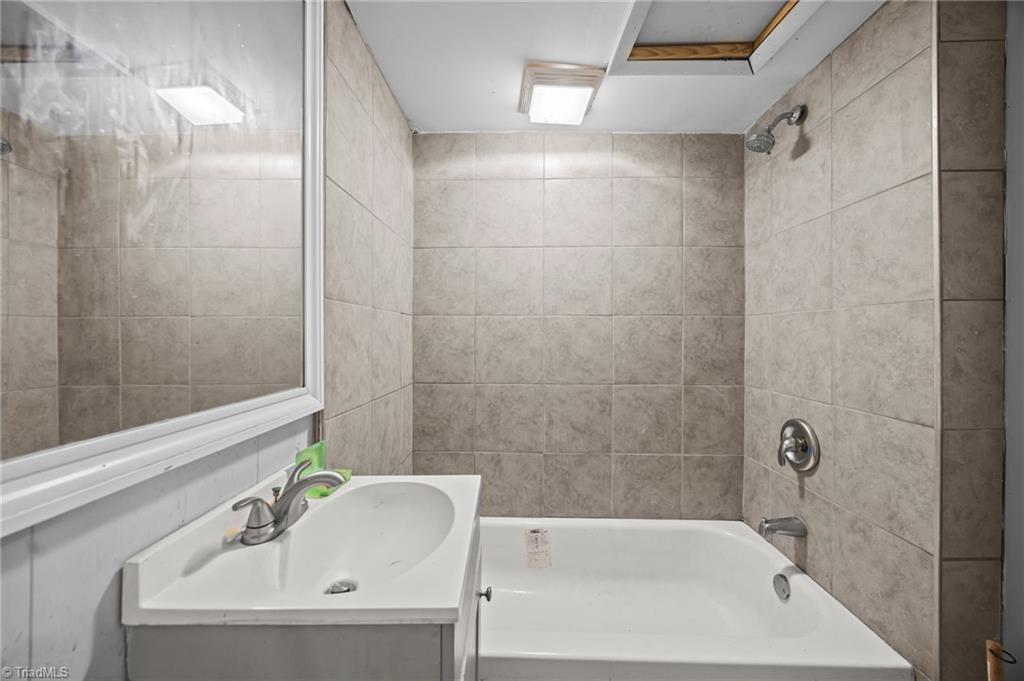 112 Briggs Place, Unit A & B High Point, NC 27262 - Photo 3 of 33 Full bathroom in Unit A with single vanity and shower & tub combo.