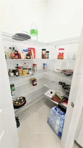a store room with lots of clutter and stainless steel appliances