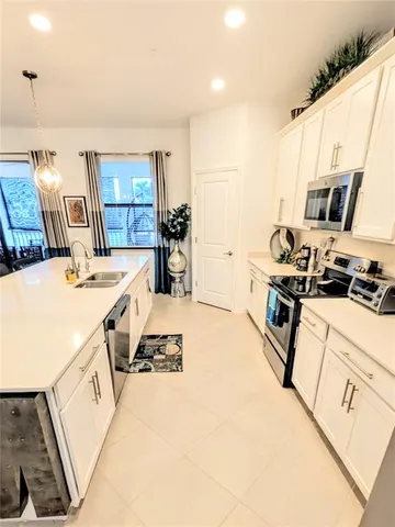 a kitchen that has a sink and a stove
