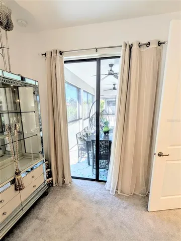 a view of a room with door wooden floor and windows