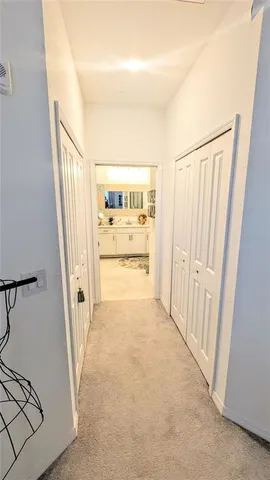 a view of a hallway to a house with wooden floor