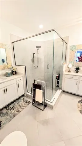 a bathroom with a sink a granite counter and a shower