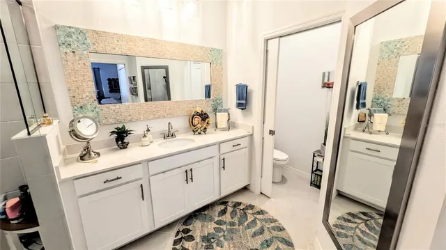 a spacious bathroom with a double vanity sink and a mirror